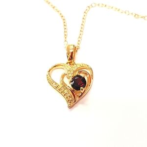 Gold and ruby heart shaped pendant necklace.